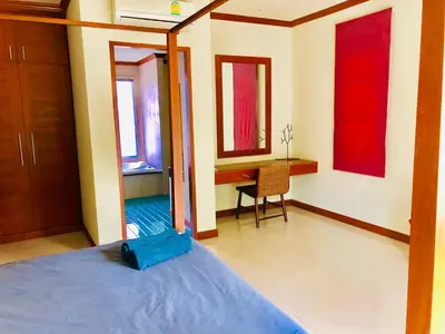 a bedroom with a bed and a desk and a table at Thai Family karon Pool Villa \u6cf0\u5982\u5bb6\u5361\u4f263\u5367\u6cf3\u6c60\u522b\u5885 in Karon Beach