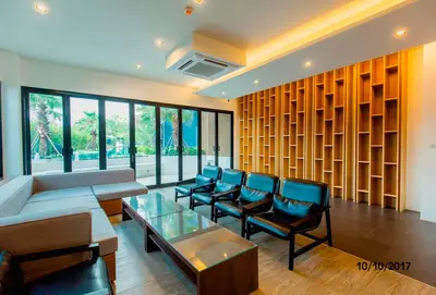 a waiting room with a couch and chairs and a table at The Aristo by Holy Cow, studio, mountain view in Surin Beach