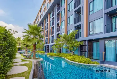 a swimming pool in front of a building at The Aristo by Holy Cow, studio, mountain view in Surin Beach