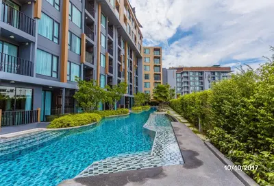 a swimming pool in the middle of a building at The Aristo by Holy Cow, studio, mountain view in Surin Beach