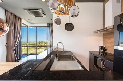 a kitchen with a sink and a large window at Lucky Holidays in Saturdays Residence in Rawai Beach