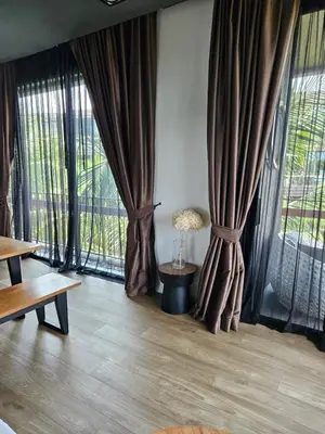 a room with large windows with curtains and a lamp at Lucky Holidays in Saturdays Residence in Rawai Beach