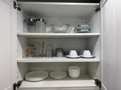 a cupboard with plates and bowls and other kitchen items at The Title Residencies Naiyang by Beringela in Nai Yang Beach