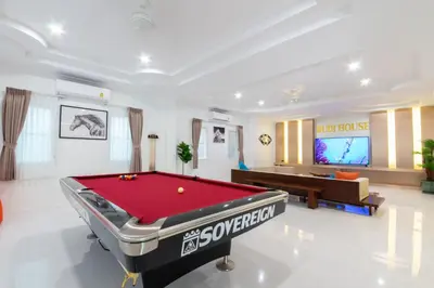 a living room with a pool table and a tv at Rudi House in Patong Beach