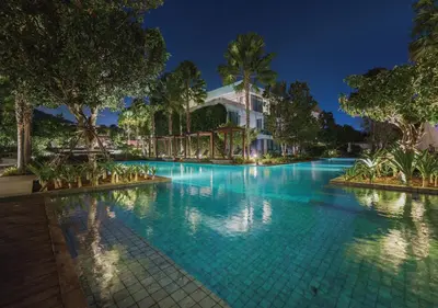 a swimming pool in a resort at night at Stay Wellbeing & Lifestyle Resort in Rawai Beach