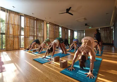 a group of people doing a yoga pose in a room at Stay Wellbeing & Lifestyle Resort in Rawai Beach