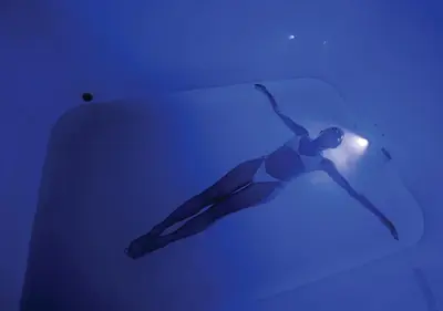 a person swimming in the water with a light at Stay Wellbeing & Lifestyle Resort in Rawai Beach