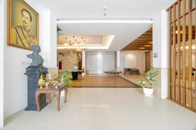 a lobby with a statue in the center of a building at Blue Beach Grand Resort And Spa in Rawai Beach