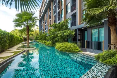a swimming pool in front of a building at Apartment at Aristo Surin by Lofty in Surin Beach