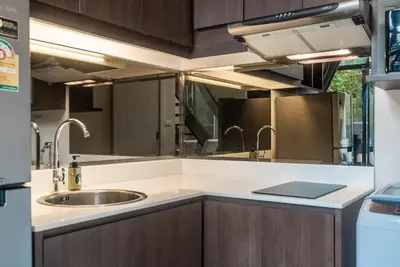 a kitchen with a sink and a counter top at Apartment at Aristo Surin by Lofty in Surin Beach