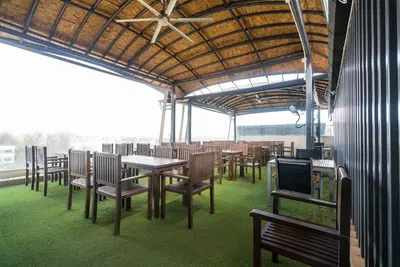 a dining room with tables and chairs and a television at Apartment at Aristo Surin by Lofty in Surin Beach