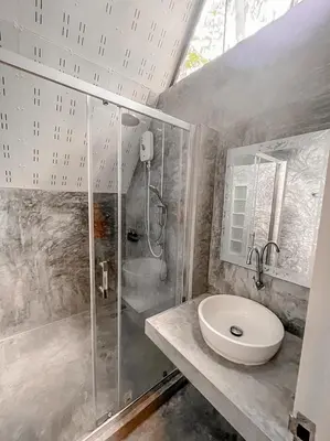 a bathroom with a shower and a sink at Baan Rai Me Rak Organic Farmstay in Ban Pa Khlok