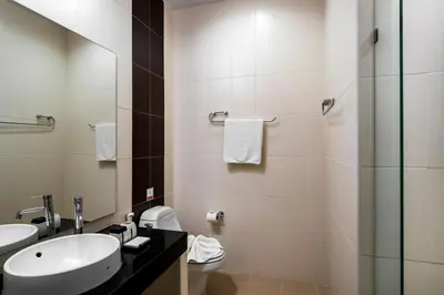 a bathroom with two sinks and a glass shower at Karon Panorama Seaview 2 Bedroom Amazing Condo in Karon Beach