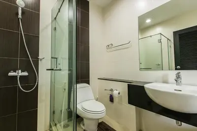 a bathroom with a toilet and a sink and a shower at Karon Panorama Seaview 2 Bedroom Amazing Condo in Karon Beach