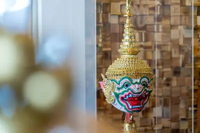 a gold pagoda with a mask on it at Hanuman VIP Hostel in Bang Tao Beach