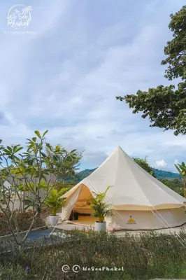 a large white tent with plants in a field at Roost Glamping - SHA Certified in Rawai Beach