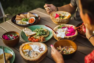 a table with bowls of food on a table at Roost Glamping - SHA Certified in Rawai Beach