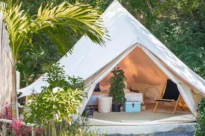 a white tent with a bed and plants at Roost Glamping - SHA Certified in Rawai Beach