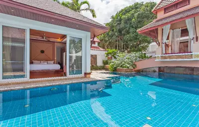 a swimming pool in front of a house at Thai style villa with very beautiful private pool in Kamala Beach