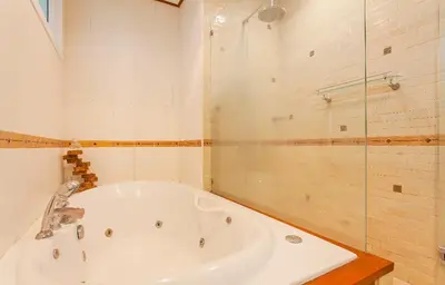 a bathroom with a tub and a glass shower at Thai style villa with very beautiful private pool in Kamala Beach