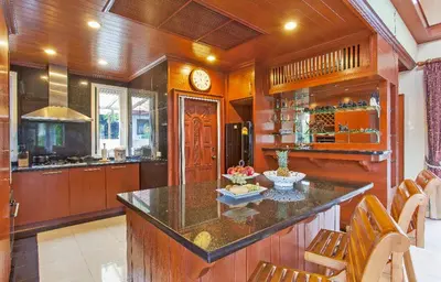 a kitchen with a large island with a counter top at Thai style villa with very beautiful private pool in Kamala Beach