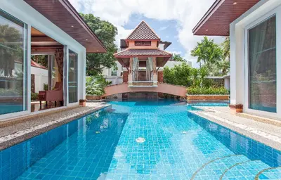 a swimming pool next to a house with a gazebo at Thai style villa with very beautiful private pool in Kamala Beach
