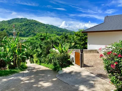 a house with a view of a mountain at Infinity Pool Apartment at Viewpoint Villas in Nai Harn Beach