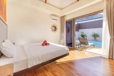 a bedroom with a large bed and a patio at New Boutique Pool Villa Sequoia Close to Rawai and Naiharn Beach in Rawai Beach