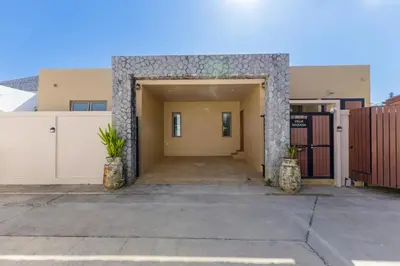 a building with an entrance with two potted plants at New Boutique Pool Villa Sequoia Close to Rawai and Naiharn Beach in Rawai Beach