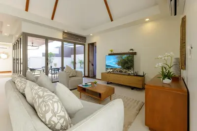 a living room with a couch and a tv at New Boutique Pool Villa Sequoia Close to Rawai and Naiharn Beach in Rawai Beach