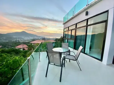 a balcony with a table and chairs on a building at 360 Degree Kamala Seaview Villa in Kamala Beach