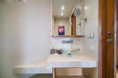 a bathroom with a sink with a glass bowl at Bright beachfront retreat in Bang Tao in Bang Tao Beach
