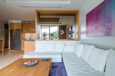 a living room with a white couch and a table at Bright beachfront retreat in Bang Tao in Bang Tao Beach