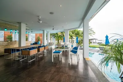 a lobby with a bar and a swimming pool at Bright beachfront retreat in Bang Tao in Bang Tao Beach