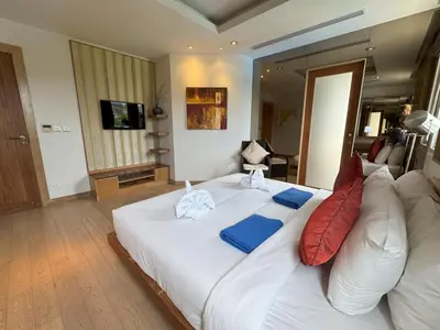 a bedroom with a white bed with red and blue pillows at Bright beachfront retreat in Bang Tao in Bang Tao Beach