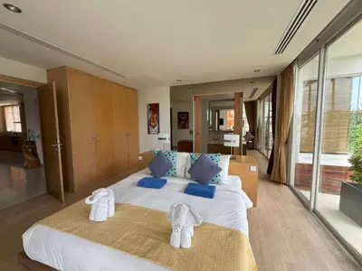a bedroom with a large bed with towels on it at Bright beachfront retreat in Bang Tao in Bang Tao Beach