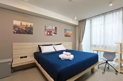a bedroom with a bed with a teddy bear on it at Oceanstone by Holy Cow, studio, next building view in Bang Tao Beach