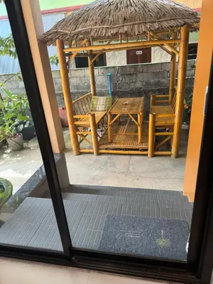 a patio with a table and chairs and a gazebo at Golf House in Ban Bang Phai