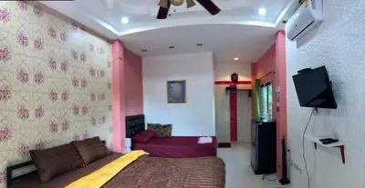 a bedroom with a bed and a flat screen tv at Golf House in Ban Bang Phai