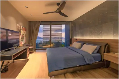 a bedroom with a bed and a desk and a ceiling fan at The Cube Ocean View Pool Villa Kalim in Patong Beach