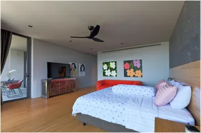 a bedroom with a bed and a ceiling fan at The Cube Ocean View Pool Villa Kalim in Patong Beach