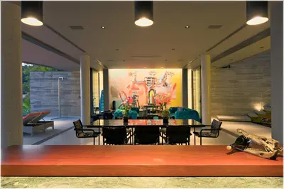 a dining room with a table and a painting on the wall at The Cube Ocean View Pool Villa Kalim in Patong Beach
