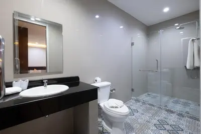 a bathroom with a toilet and a sink and a shower at Blue Beach Apartment in Rawai Beach