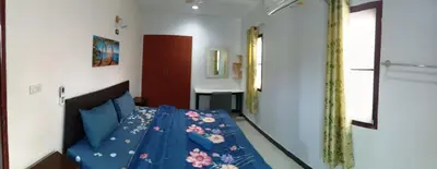 a bedroom with a bed with blue sheets at 2BR Maryam villa near Tesco & beach. in Bang Tao Beach