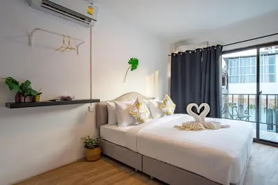 a bedroom with a bed with a heart decoration on it at Isara Boutique Hotel and Cafe in Phuket Town