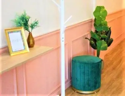 a green vase with a plant in a room at Isara Boutique Hotel and Cafe in Phuket Town