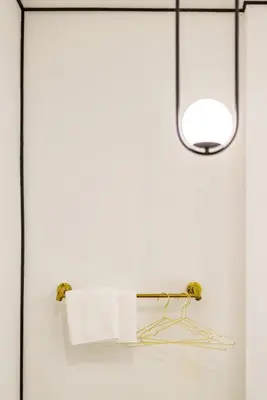 a bathroom with a towel rack and a light at Isara Boutique Hotel and Cafe in Phuket Town