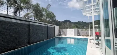 a swimming pool on the side of a building at Villa Kamala close to the beach in Kamala Beach