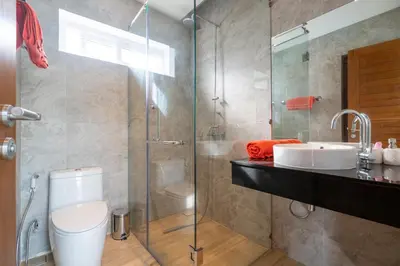 a bathroom with a shower and a toilet and a sink at Villa Kamala close to the beach in Kamala Beach