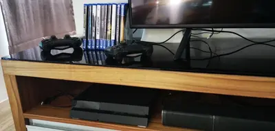 a television with two video game controllers on a shelf at Villa Kamala close to the beach in Kamala Beach